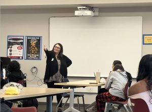 At the first Speech and Debate club practice of the year, speech coach Jenny Cook delivers announcements. 