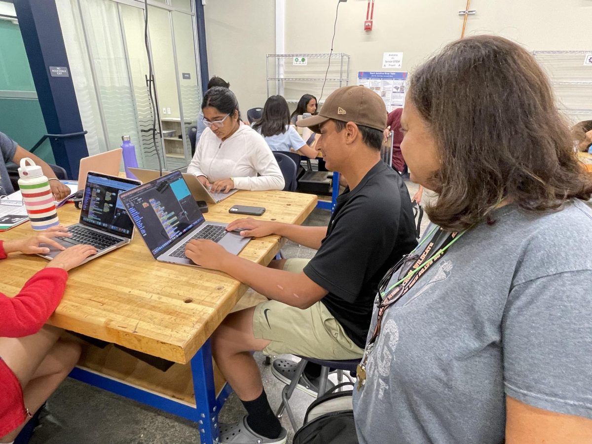 Lalitha Maruvda helps freshman Brooklyn Harman test his nearly complete Pong game on Sept. 13.