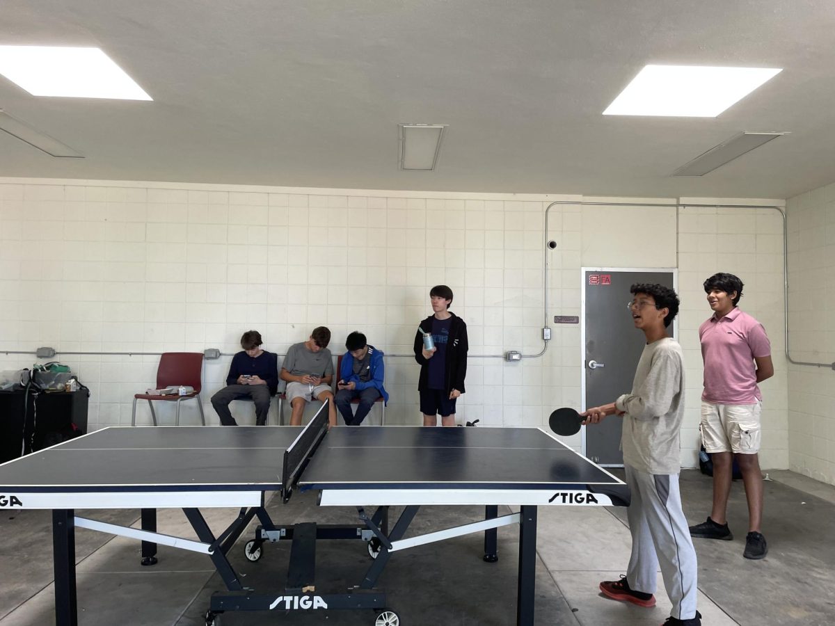 Freshmen Arjun Vijaykumar, Samir Sharma and Adrian Etter play Ping Pong during lunch.