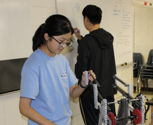 Junior Nicole Hao works on her team’s robot on her lift mechanism. 