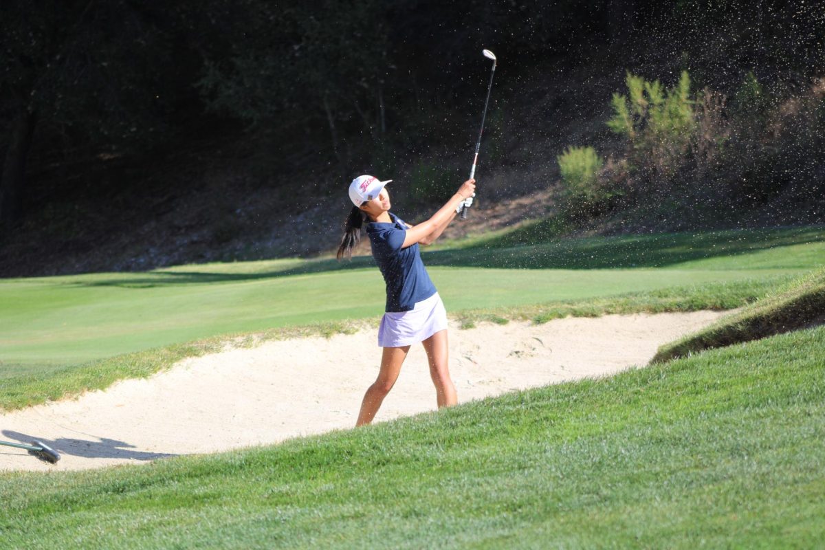 Junior Millie Wang hits a 54-degree wedge out of a bunker at Saratoga Country Club.