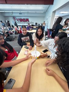 During their first meeting on Sept. 12, Slime Club members mix a large bowl of glue with an activator to make slime.