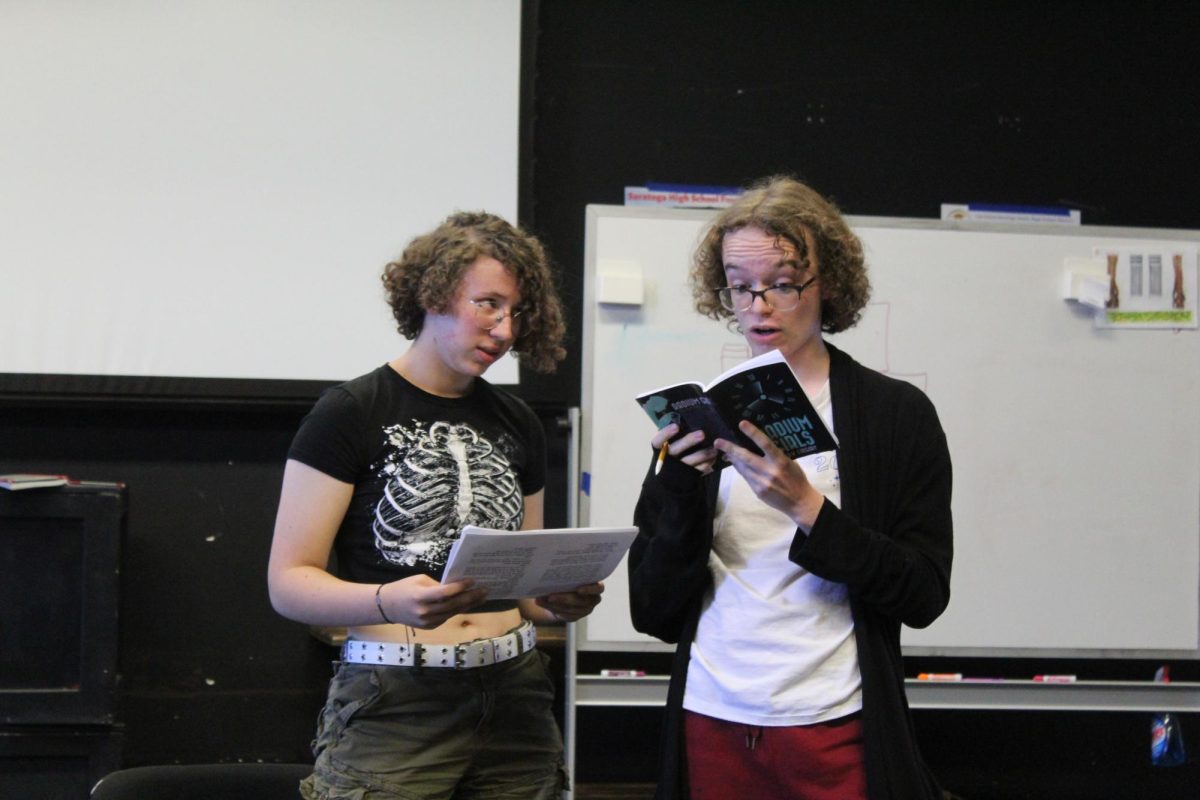 Freshman Tessie Berger (left) plays the role of Raymond Berry, an attorney for the dial painters with junior Ben Davies (right) who plays the role of Edward Markley, a counsel for the U.S. Radium Corporation.