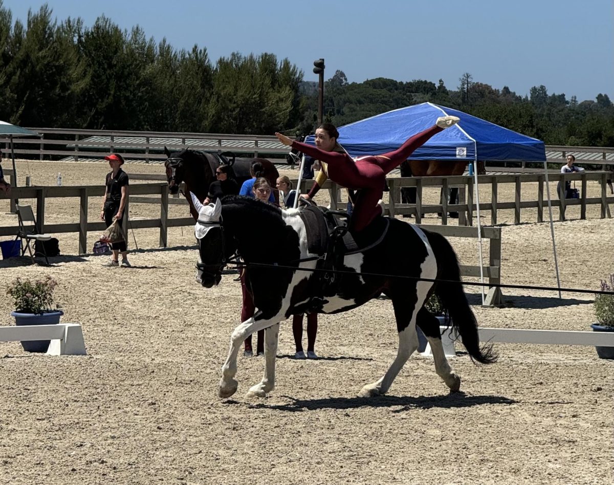 Alice Vaughan balances in the flag position while practicing her solo performance at Garrod Farms.