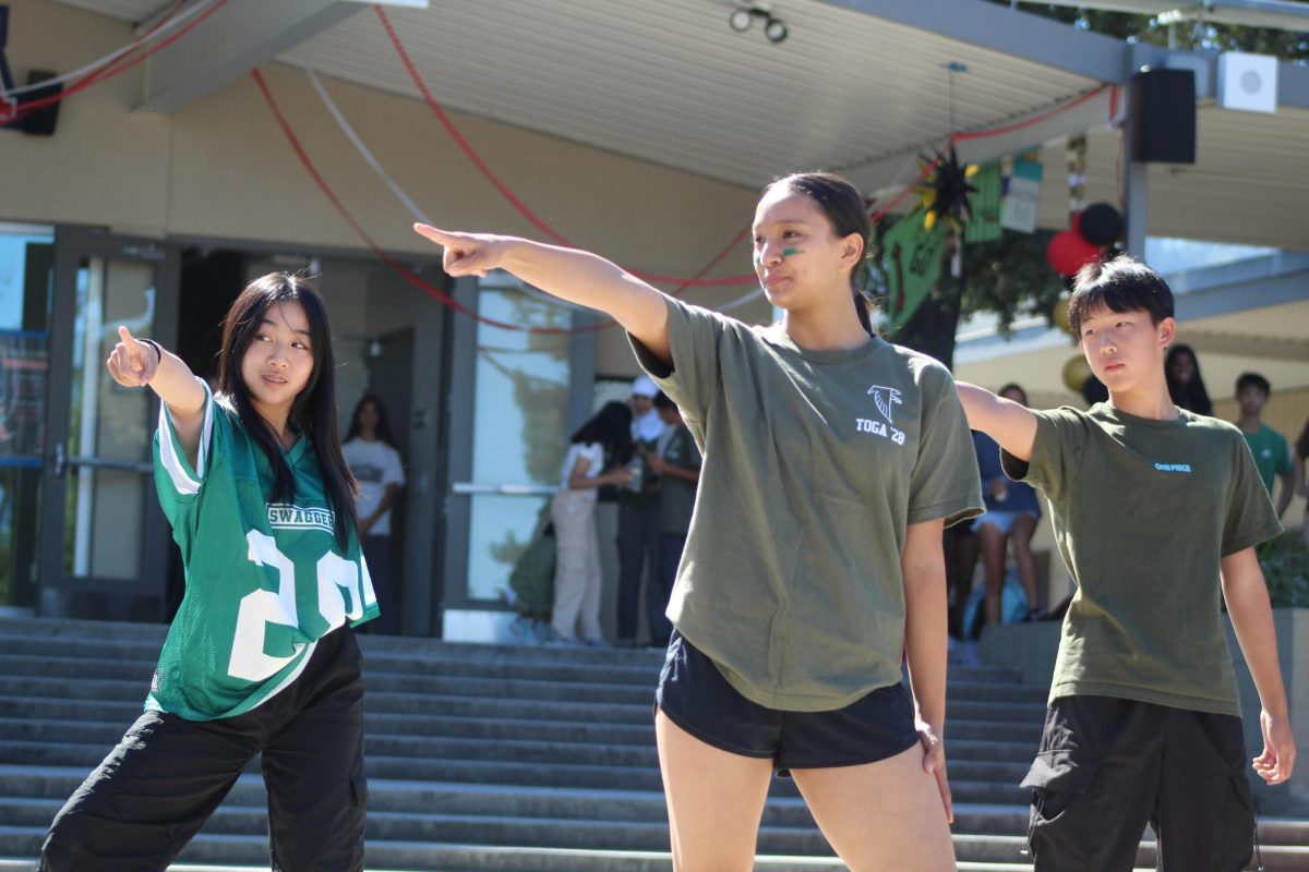 Elaine Luo (left), Mira Jishnu (center), and Joseph Yu pose for the K-Pop dance.