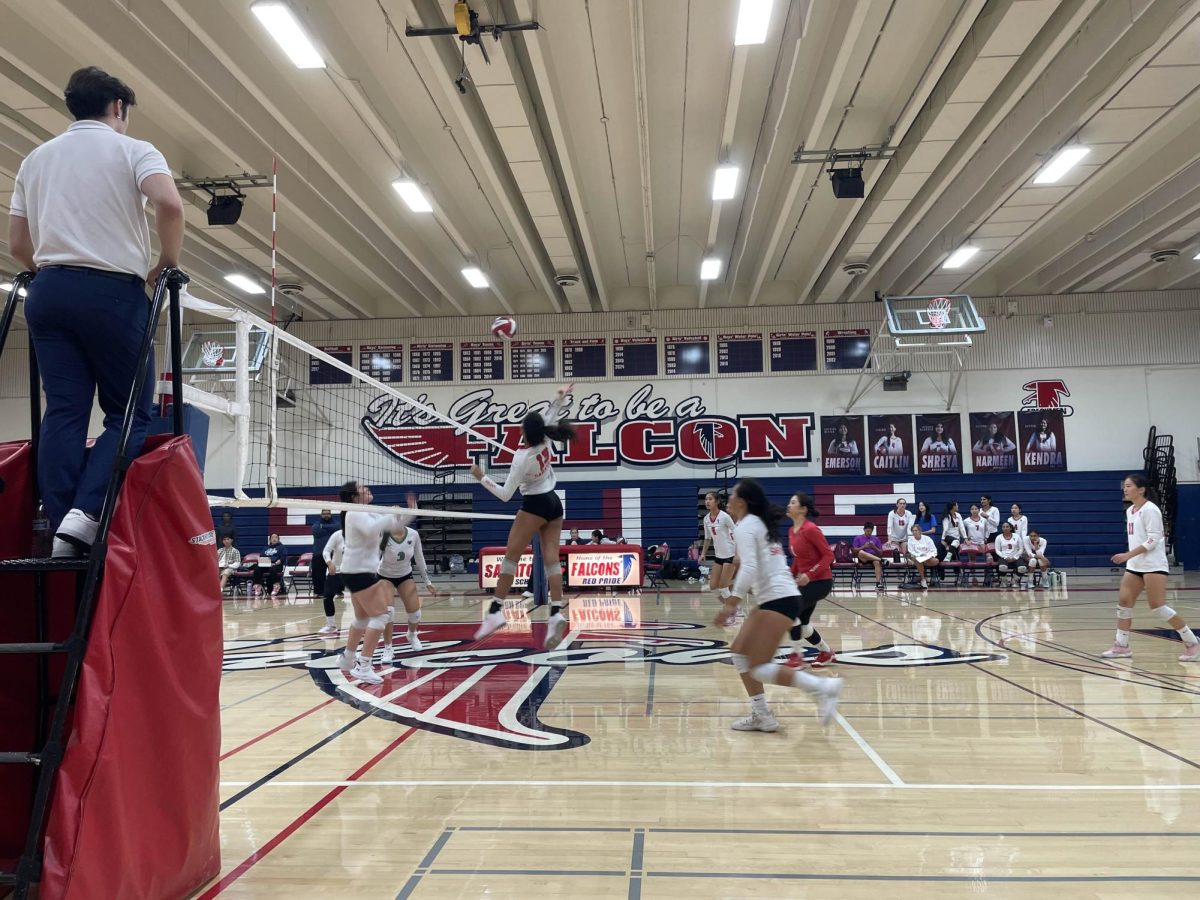 Middle Blocker Aanya Hotha swings backward to spike the ball over the net.