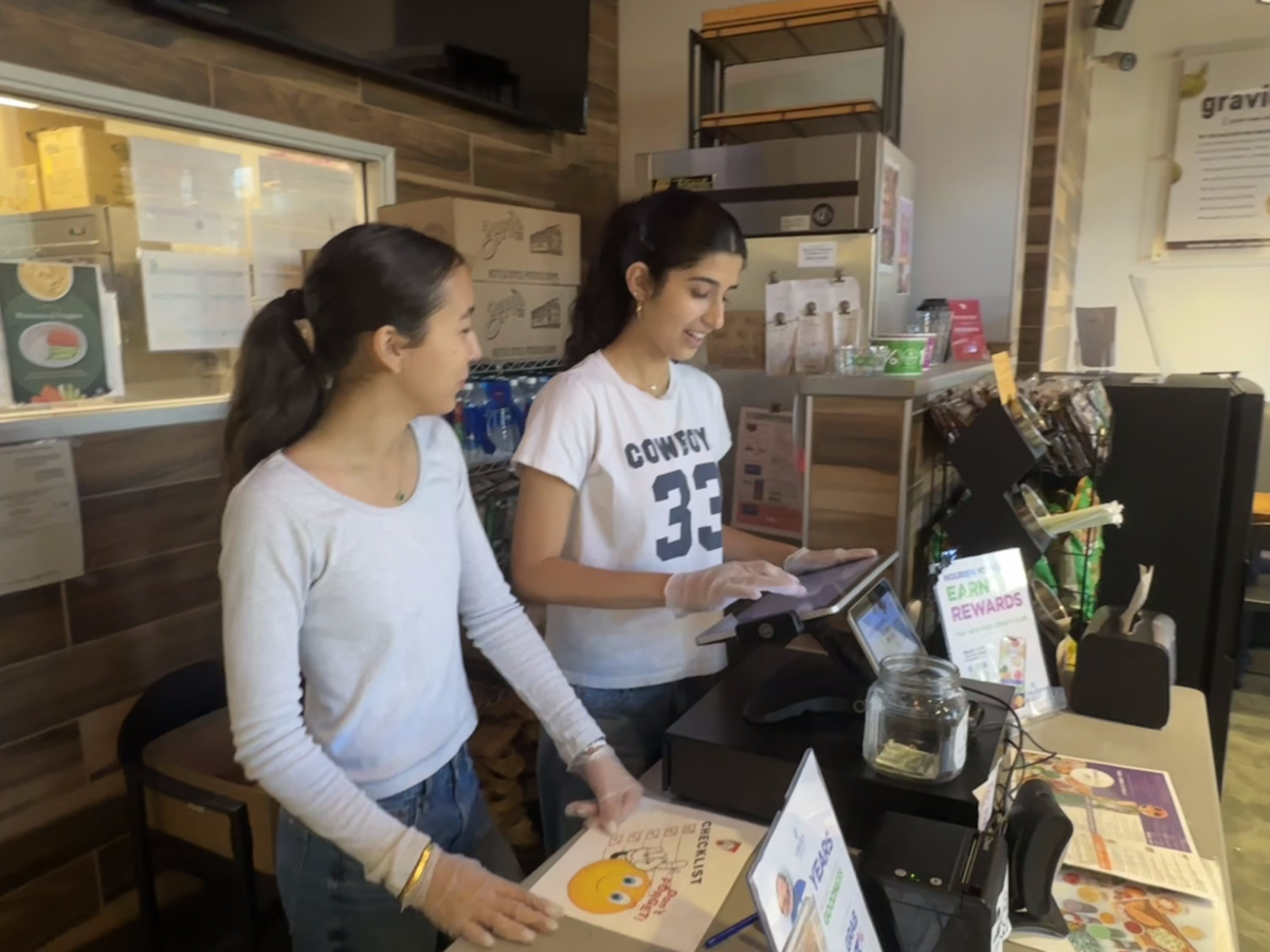 Hendley and Mohr take a customer’s order at the cash register.