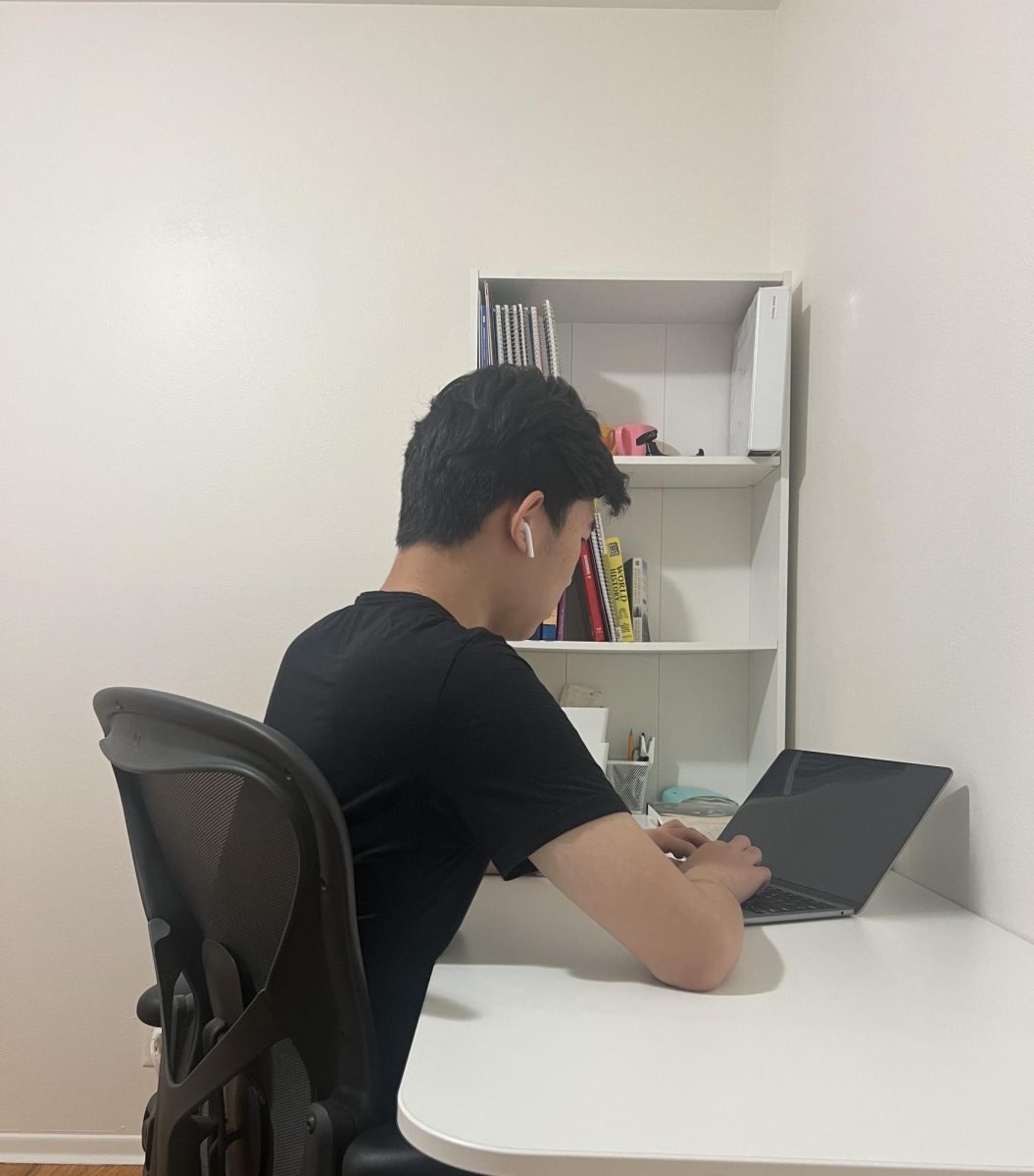 Real-life image of my friend with AirPods while studying.