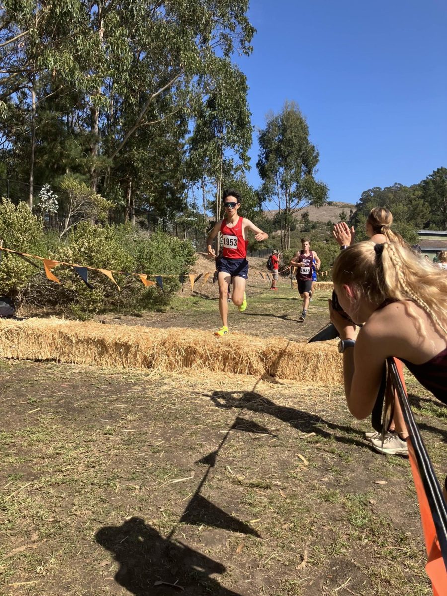 Junior Jack Dong jumps over a hay bale at the Artichoke Invitational at Half Moon Bay High School on Oct. 5.
