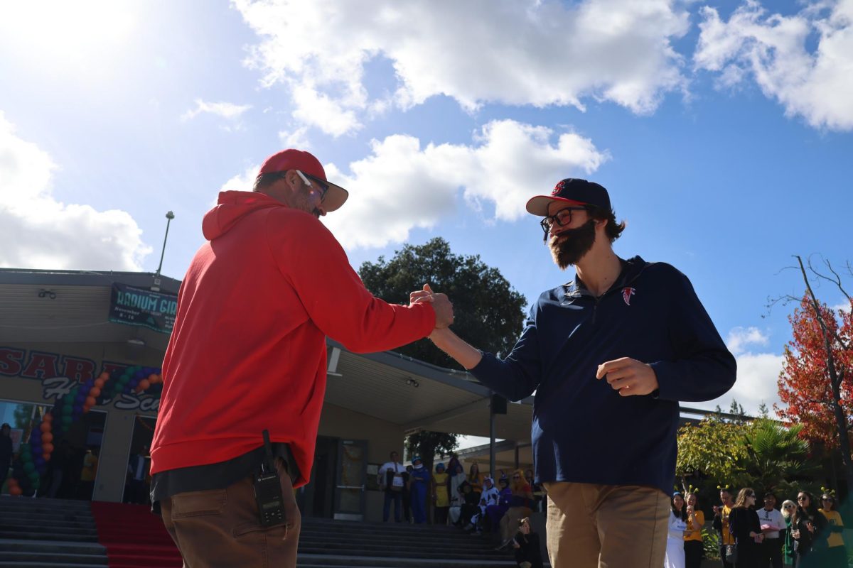 Sophomore quarterback Anson Hulme dresses up as his coach Archie Ljepava, capturing his signature baseball cap, glasses and beard.
