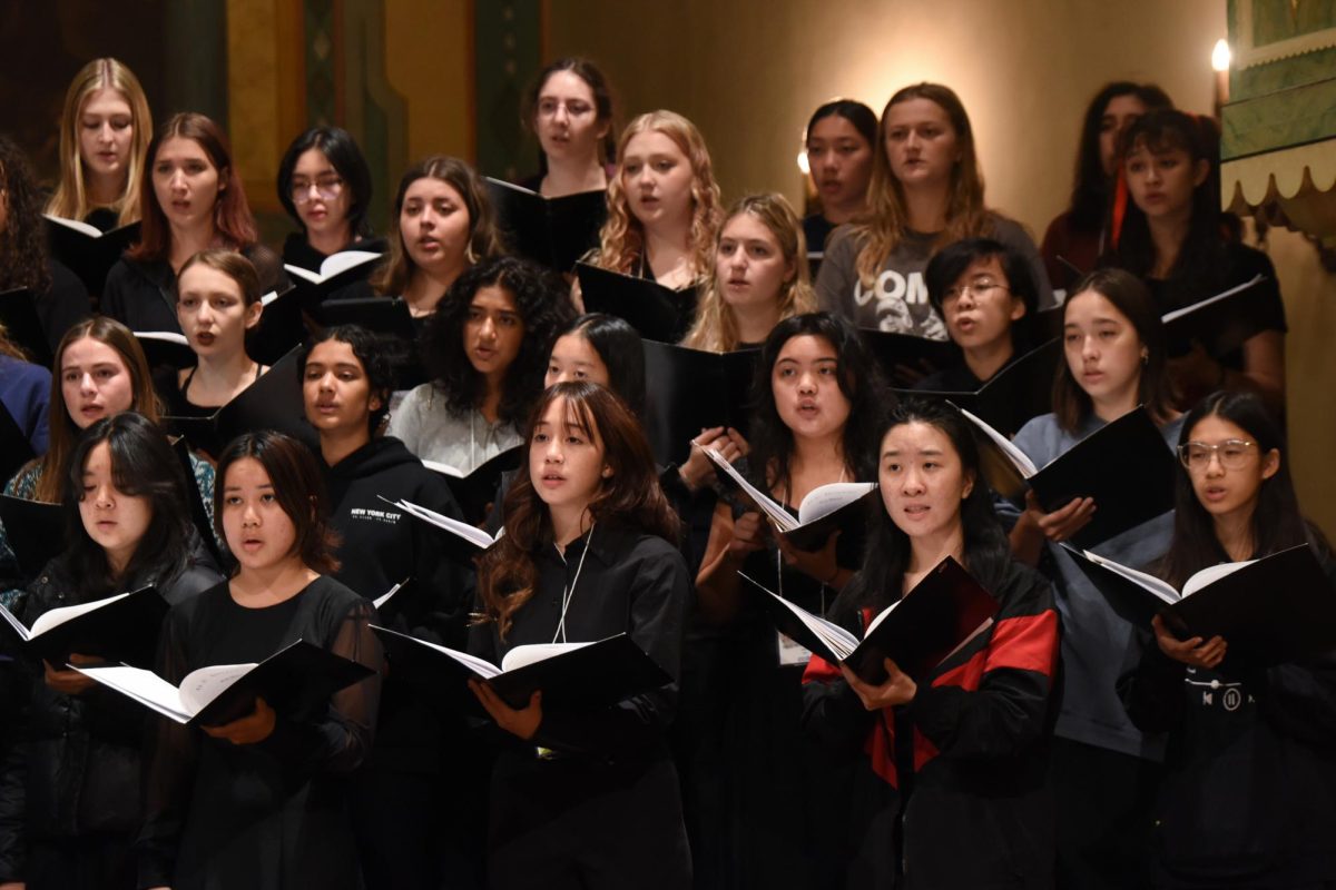 Senior Aria Zhang and sophomore Sophie Poon (bottom right) perform in their SSAA ensemble among other talented students from other schools