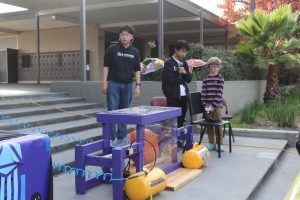 A child presses on the button, triggering the smasher.
