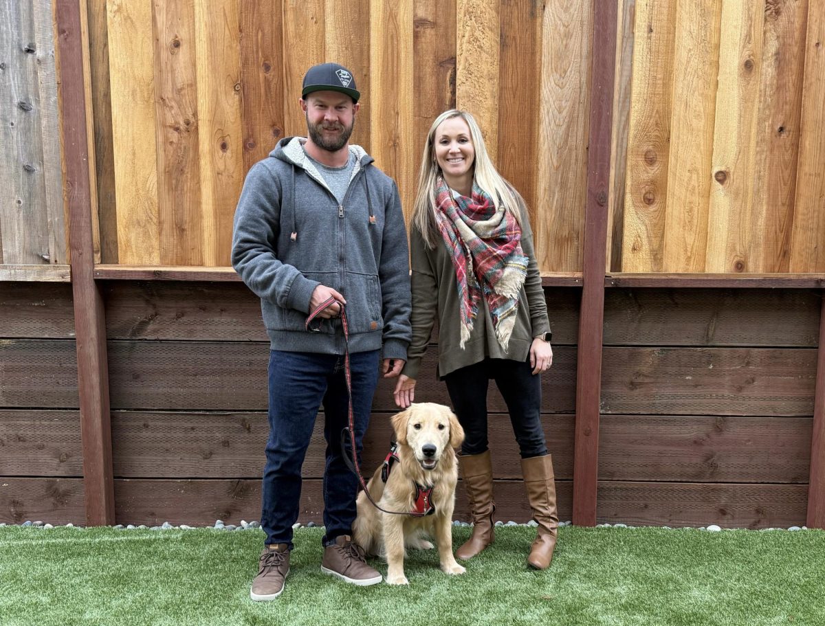 Mr. and Mrs. Laws with Finley in their backyard.
