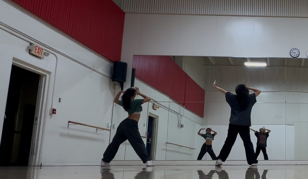 Senior Anisa Taymuree learns her solo dance alongside her choreographer Karen Chien.