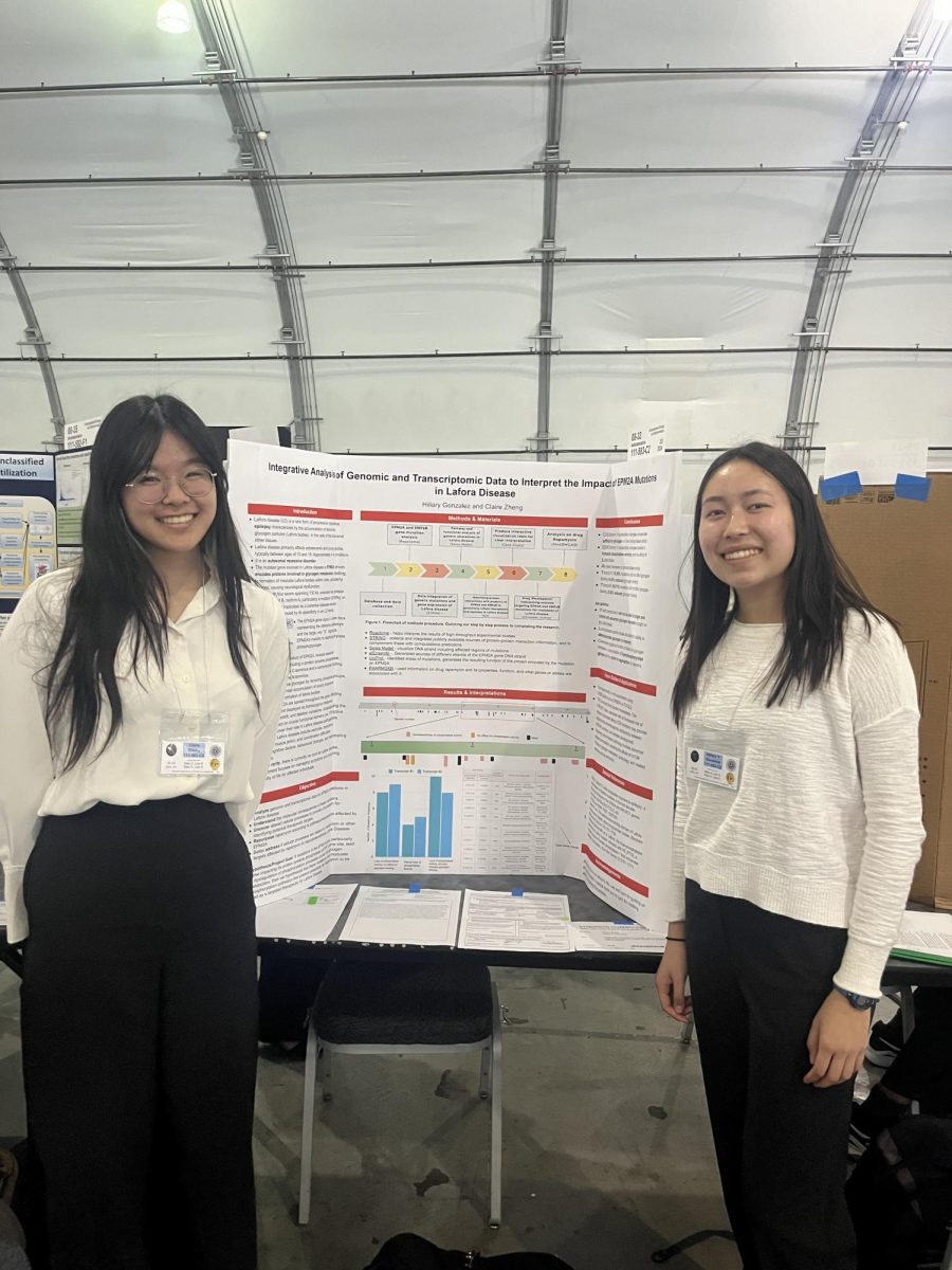 Seniors Hillary Gonzalez and Claire Zheng present their project with the help of the ASRC Club at the Synopsys Science Fair.