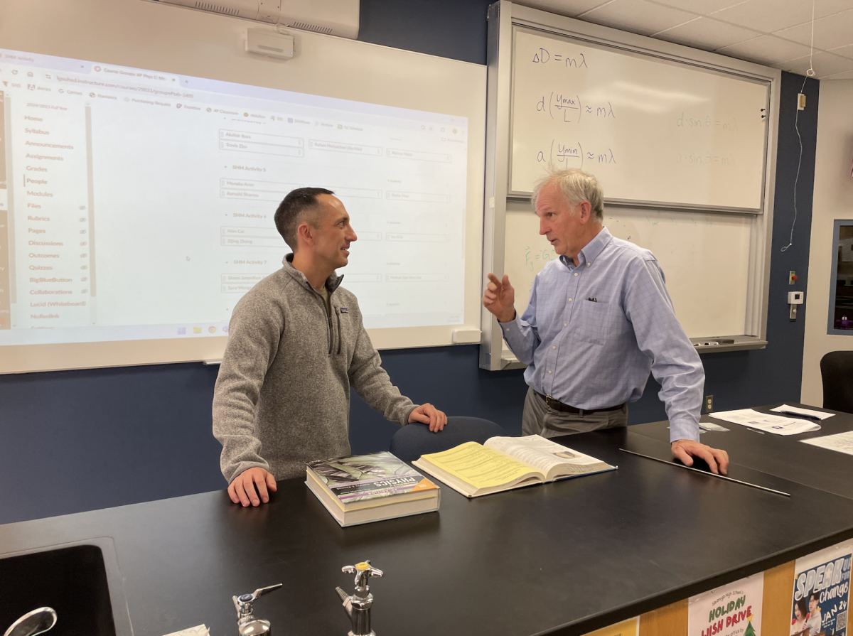 AP Physics teachers Tom Casavant and Matthew Welander discuss a change in their upcoming lesson plans.