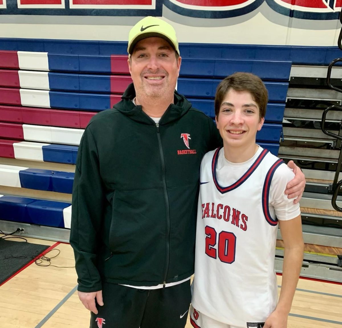 Jerry Sheehy and Cole Sheehy pose together after a JV basketball game.