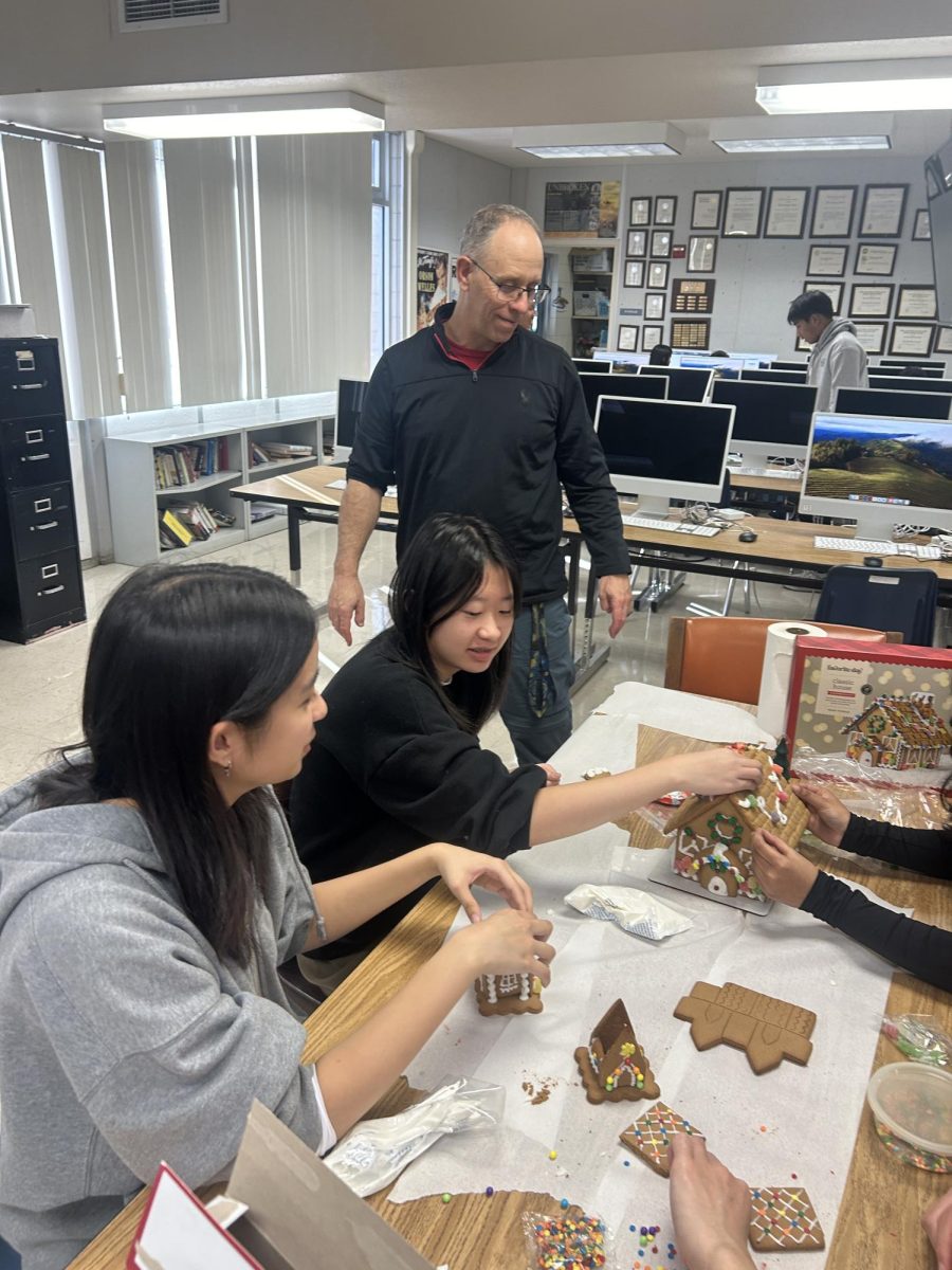 Photo by Jane Lee
Mr. Tyler grins, extremely pleased with the seniors’ gingerbread house product. 