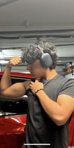 Junior Ishir Ayyagari flexes after an arm workout.
