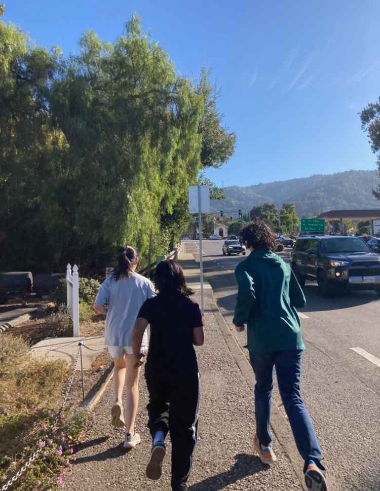 Cellists Aryan Shrivastava, Mridhula Vudali and Katherine Zeng run along a route to Saratoga downtown.