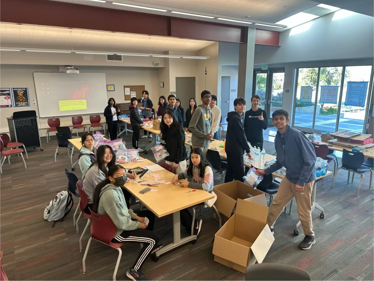 Students from Future Business Leaders of America and Inspiring Future America work on survival kits Sacred Heart in the Student Center.