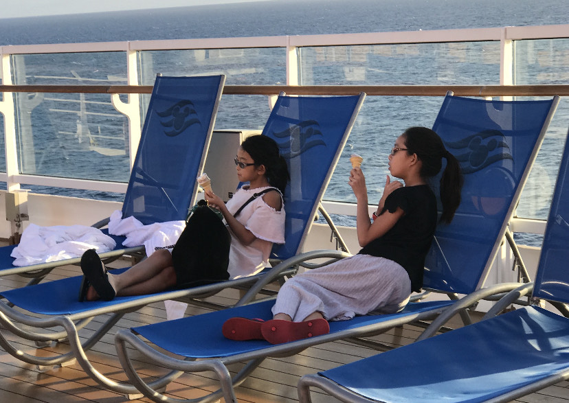 My sister and I eating ice cream and relaxing on the pool deck after our treacherous adventure.
