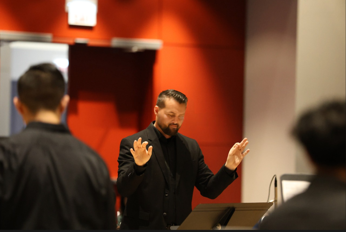 Clark conducts a piece for the SHS Percussion at the Midwest Clinic.