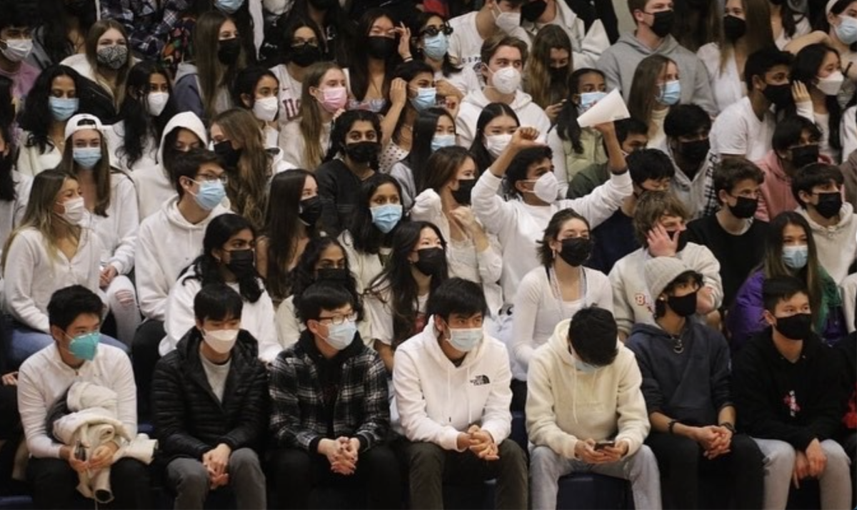 Masked students cheer during a basketball game against Los Gatos High in 2022 — the first year after lockdown.