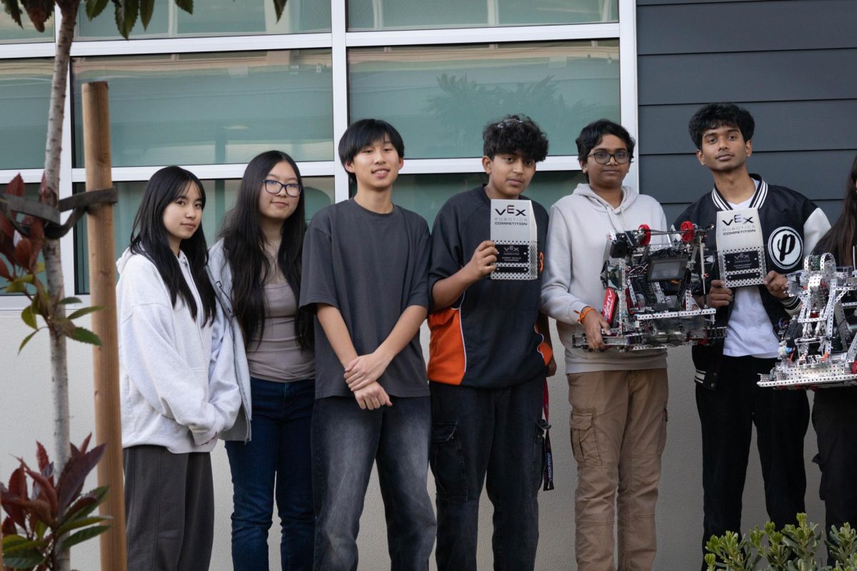 Sophomore Eric Liang and his VEX team 2041V pose for a photo after winning a competition
