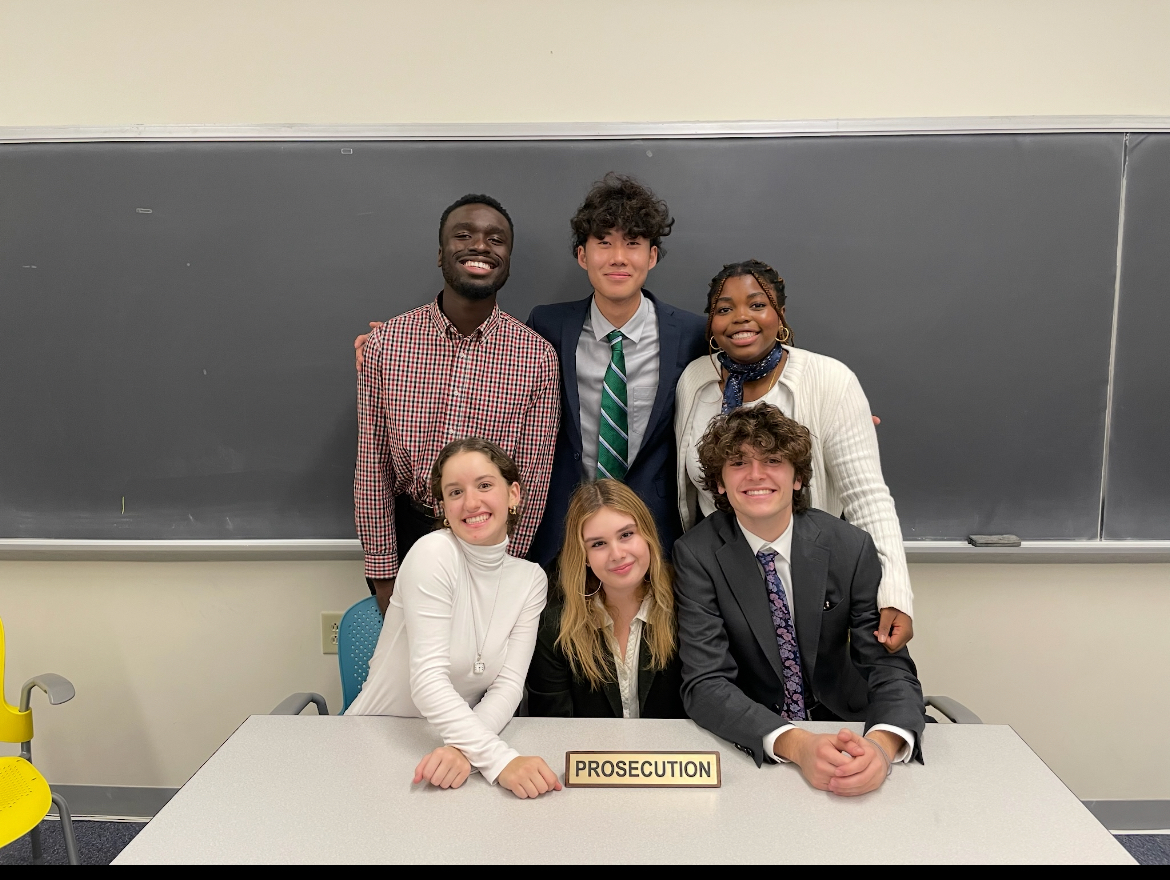 Zinman (bottom right) poses with Tufts’ Mock Trial team.