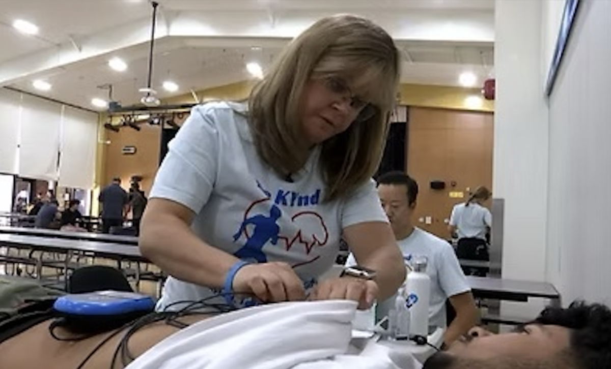 Volunteers from the Kyle J Taylor Foundation conduct a heart screening for high school student athletes.