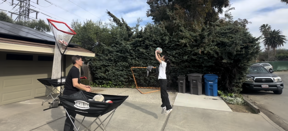 Iris gets some setter reps while practicing with her dad.