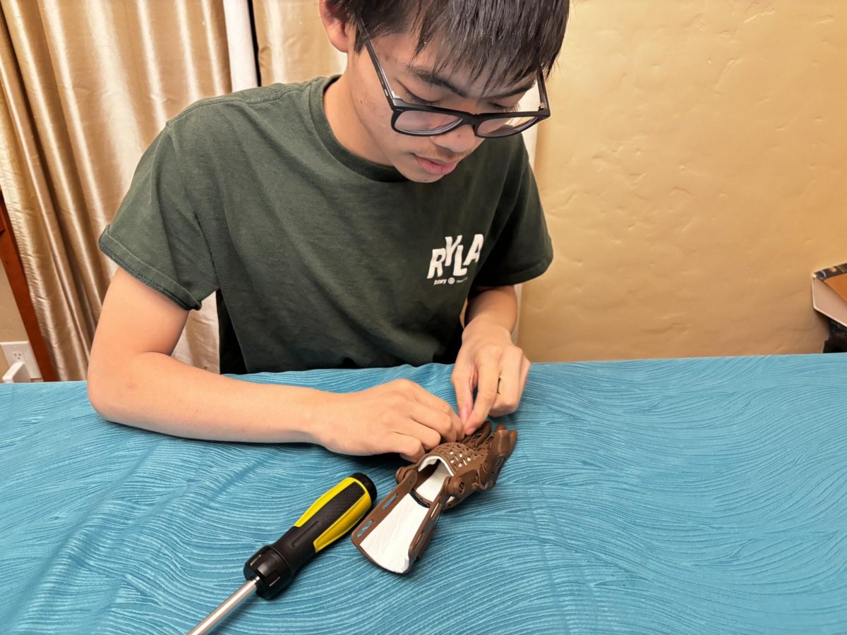 Sophomore Cuttlefish member Maxwell Tham works intently on his Phoenix Unlimbited Hand in order to get certified by e-NABLE.   
