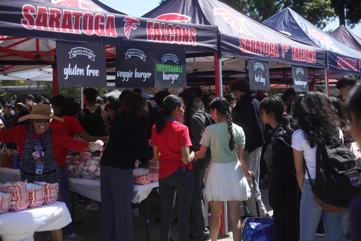 Students wait in line for burgers and hot dogs.