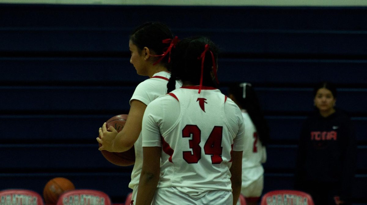 Junior Dhatri Iyer surveys the court during a girls varsity basketball game.
