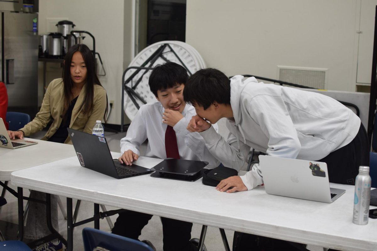 Sophomore Michael Duan and Junior Richard Chen plan their rebuttal in the middle of a debate round.