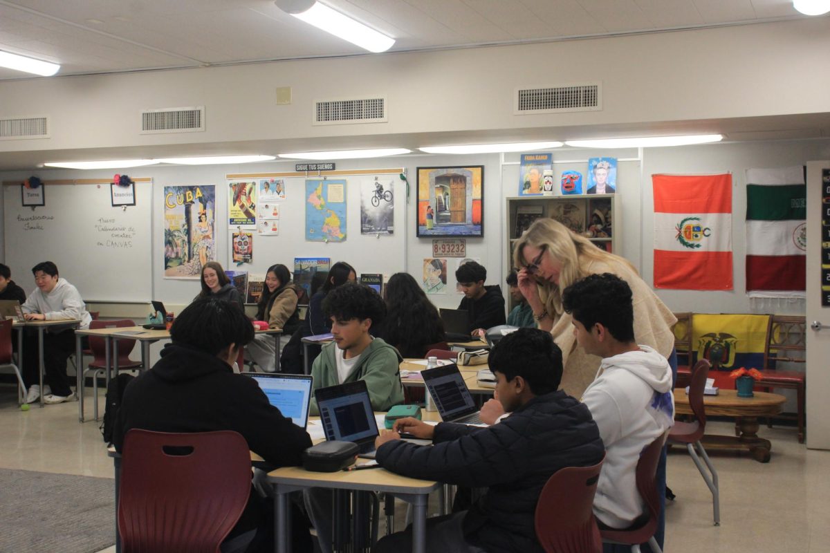 Spanish Teacher Stephanie Marks helping students with their presentations