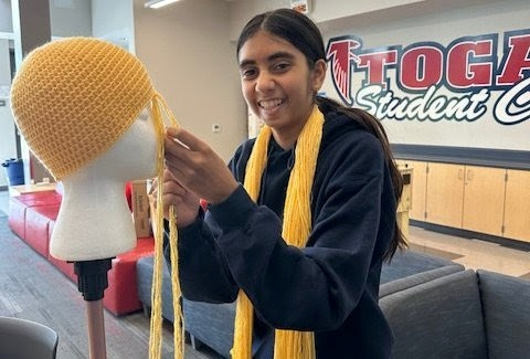 Sophomore and volunteer Dhriya Darji crochets a wig for the Magic Yarn Project