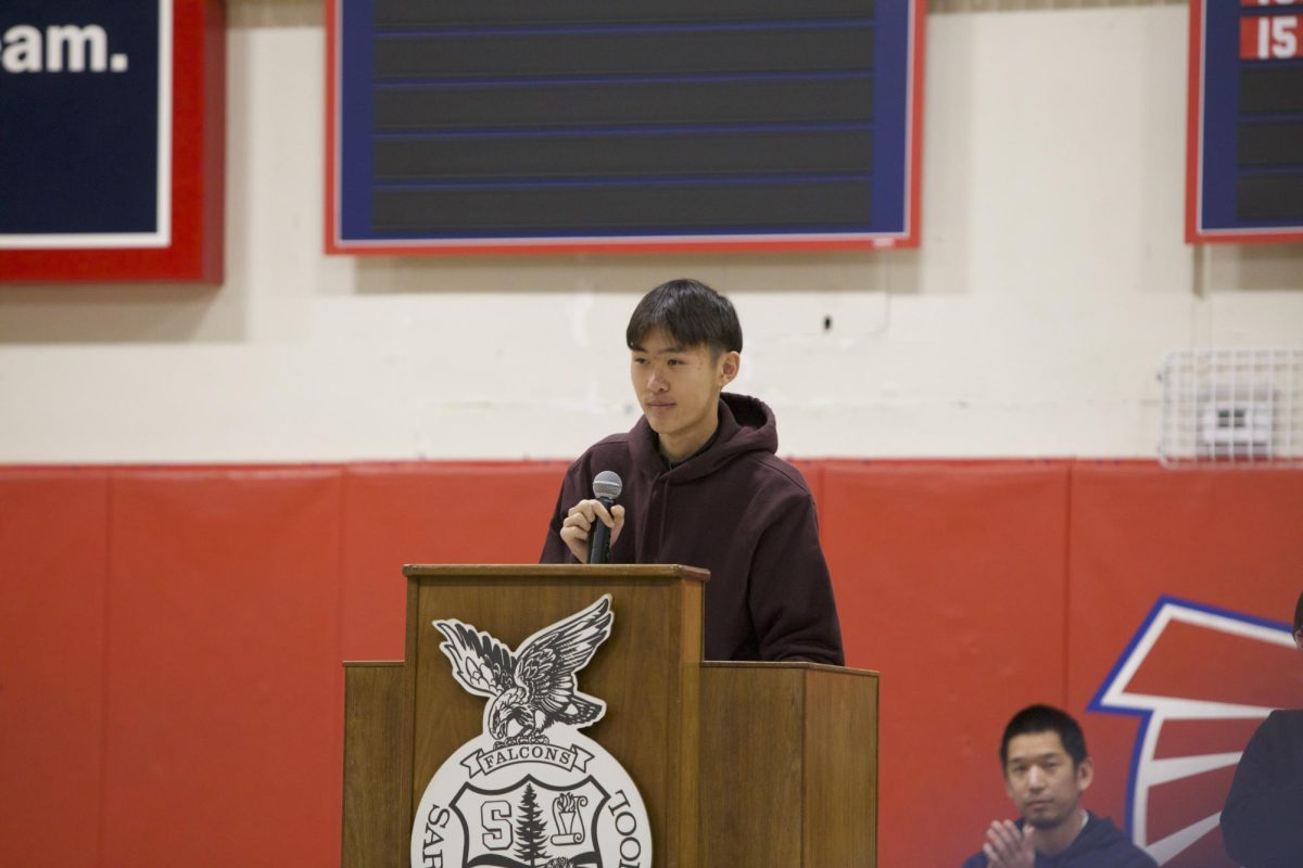 Wang presents his speech in the large gym during the rally.