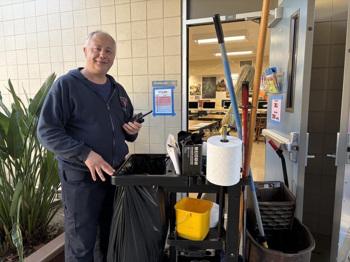 Night crew member Archer Guleroglu prepares to enter the journalism class to clean the classroom for the next school day.