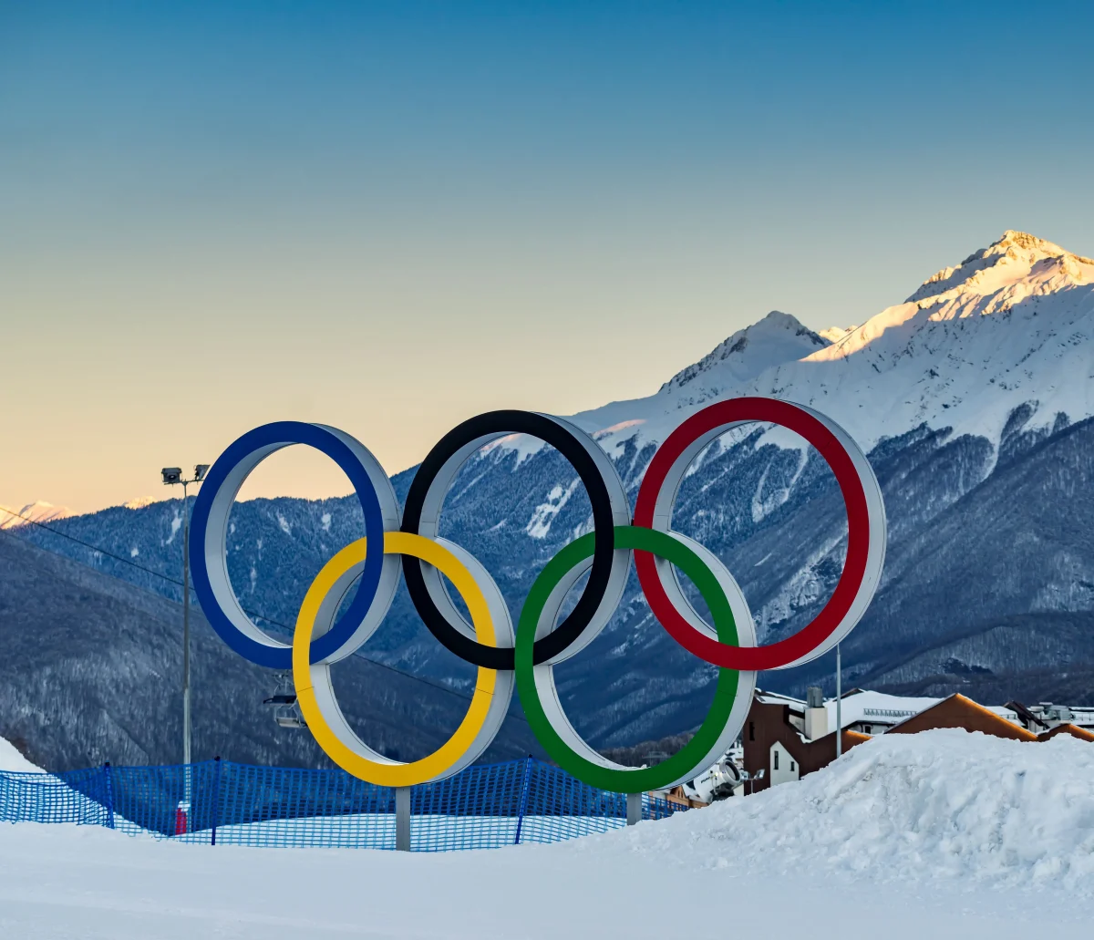 The Olympic rings sit on a carpet of snow in Italy.