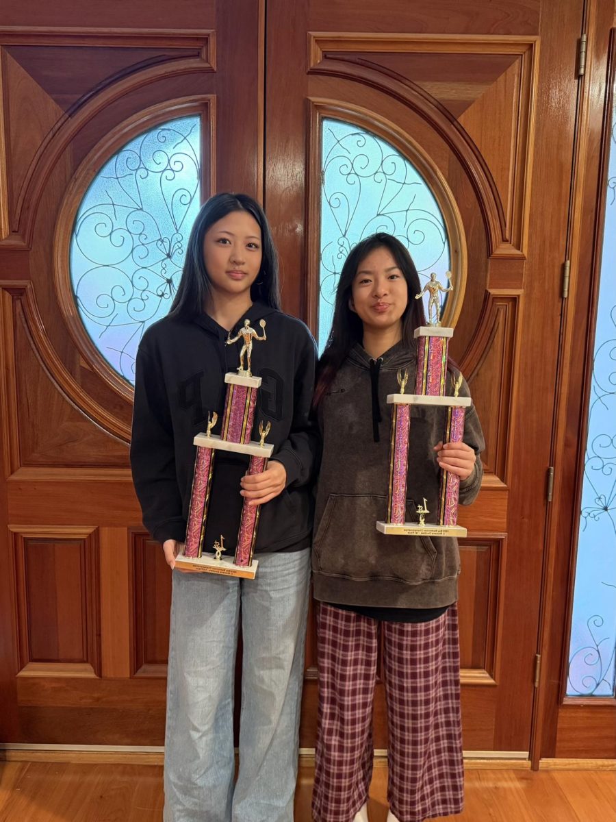  Courtesy of Selina Xu 

Selina Xu (left) stands with her double partner sophomore Angela Wang of Walnut High in Los Angeles County, holding trophies.