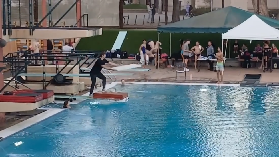 Sophomore Katie Lee is mid-somersault in a dive.