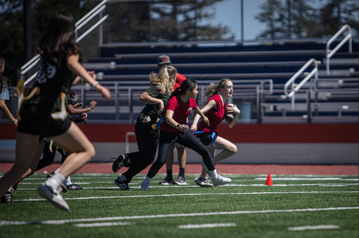 Senior Ava Cai screens for Sophia Faraone as she runs past defenders.