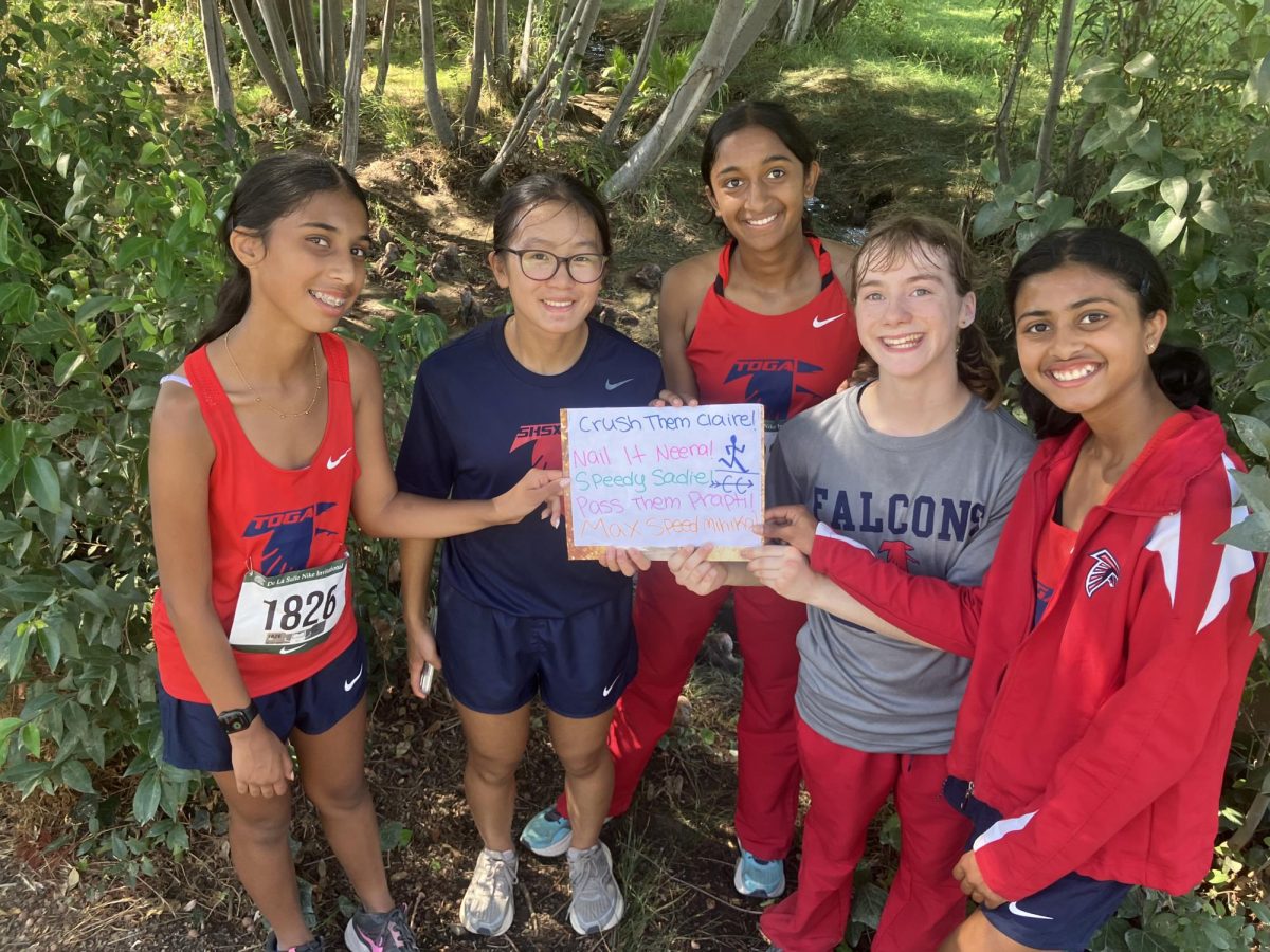 Members of the girls’ cross country team pose for a photo  after the De La Salle Nike Invitational last fall.