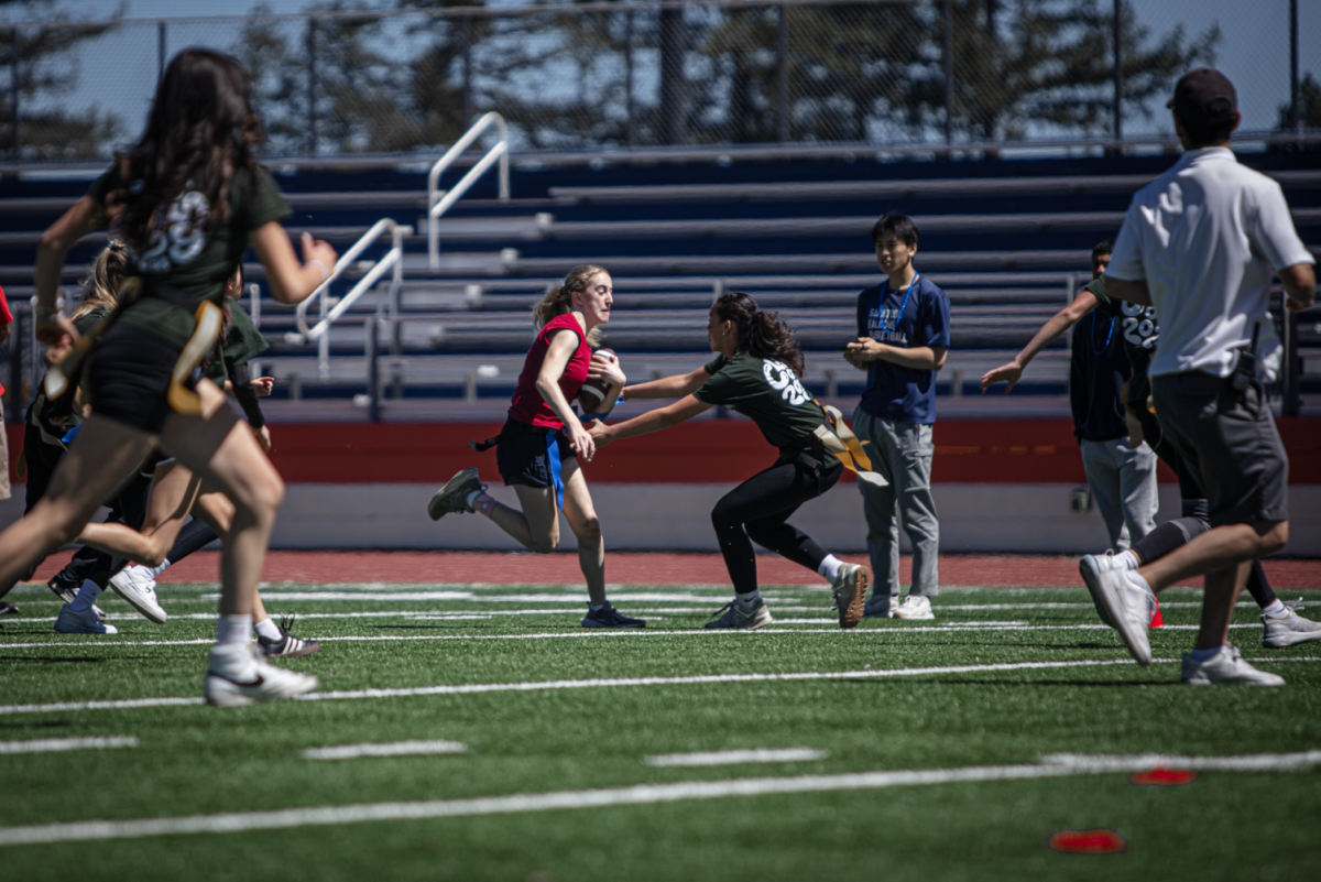 Sophia Faraone runs with a football during their game against the freshmen this year.
