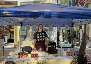  Courtesy of Elizabeth Pattullo
Pattulo poses at Silver Lining Honey’s stand at the Santana Row farmers’ market.